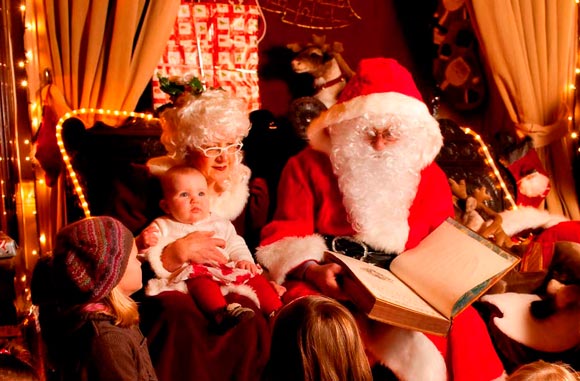 Santa and Mrs Claus reading to children at Westport House Winter Wonderland